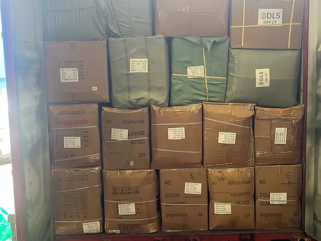 Neshat team staging cartons at the Yiwu warehouse before a container is loaded